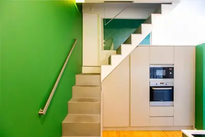 a staircase with green walls and a green wall at Casa da Cordoaria by Oporto Soul in Porto