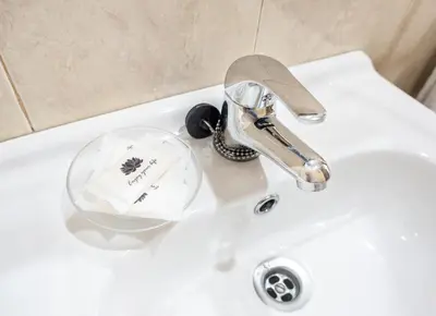 a bathroom sink with a faucet on a sink at Almada Guest House in Porto