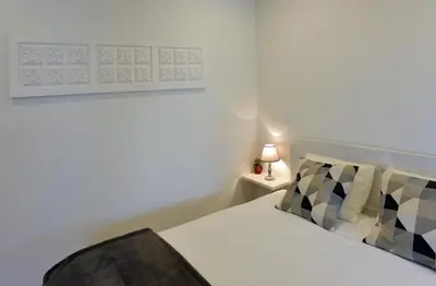 a bedroom with a bed and a lamp on a night stand at Oporto Memory Houses 7 in Porto