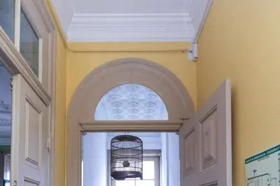 an archway over a door with a bird cage at Oporto Sky Hostel in Porto