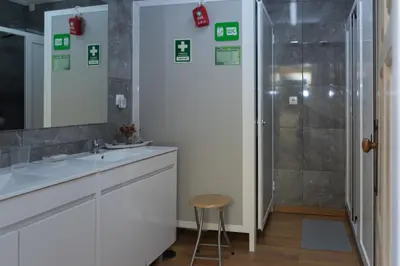a bathroom with a sink and a shower at Oporto Sky Hostel in Porto