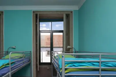 a room with two bunk beds and a window at Oporto Sky Hostel in Porto