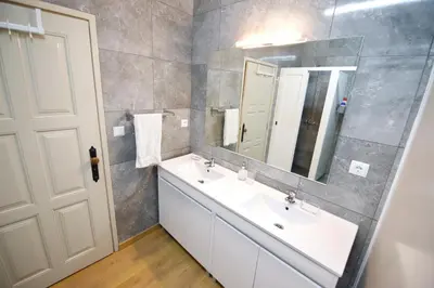 a bathroom with a white sink and a mirror at Oporto Sky Hostel in Porto