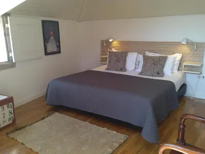 a bedroom with a large bed in a room at PortoSense Ribeira in Porto