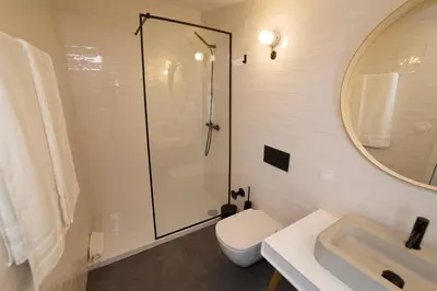 a bathroom with a shower and a toilet and a sink at Oporto Design Attic - Solar da Avenida in Porto