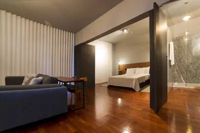 a bedroom with a bed and a couch and a table at Oporto Cozy Design Studio - Solar da Avenida in Porto