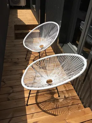 two white tables sitting on a wooden deck at Oporto Cozy Design Studio - Solar da Avenida in Porto