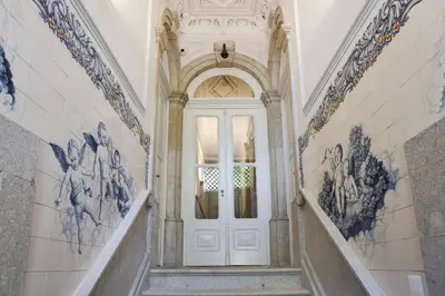 a white door in a hallway with paintings on the walls at Oporto Cozy Design Studio - Solar da Avenida in Porto