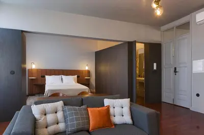 a living room with a couch and a bed at Oporto Cozy Design Studio - Solar da Avenida in Porto