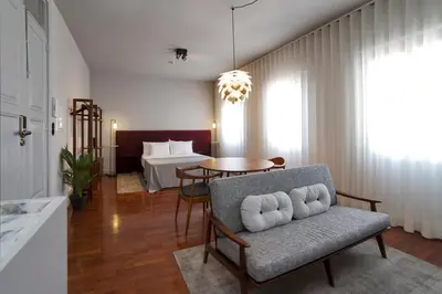 a living room with a chair and a table at Oporto Cozy Design Studio II - Solar da Avenida in Porto