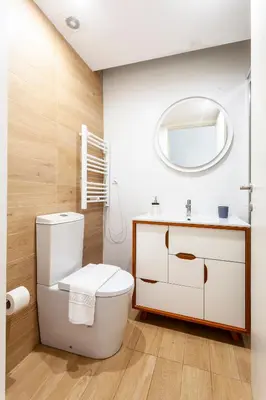 a bathroom with a white toilet and a mirror at Citybreak-Apartments Poveiros in Porto