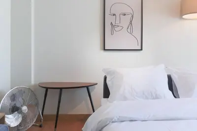 a bedroom with a bed and a table and a picture at Republica Deluxe Apartment in Vila Nova de Gaia