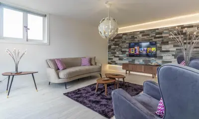 a living room with two couches and a tv at House General Torres in Vila Nova de Gaia