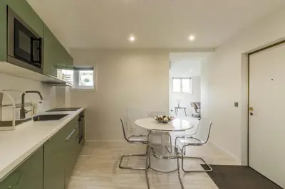 a kitchen with a small white table and chairs at House General Torres in Vila Nova de Gaia