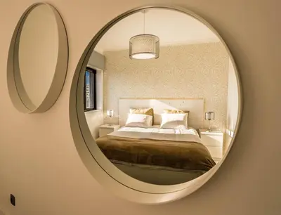 a bedroom with a bed and a large mirror at House General Torres in Vila Nova de Gaia