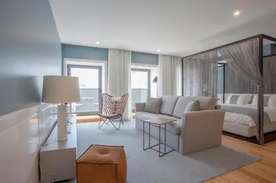a living room with a couch and a bed at Liiiving in Porto | Downtown Luxury Studio in Porto
