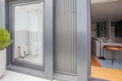 a room with a large glass window in a room at Liiiving in Porto | Downtown Luxury Studio in Porto