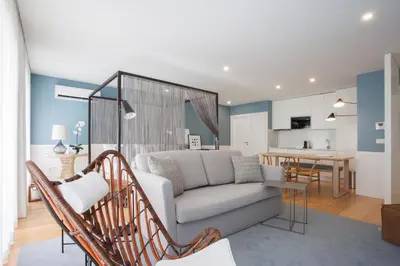 a living room with a couch and a kitchen at Liiiving in Porto | Downtown Luxury Studio in Porto