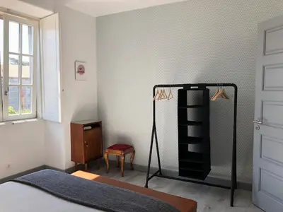 a bedroom with a bed and a black book shelf at Casa da Catedral II in Porto