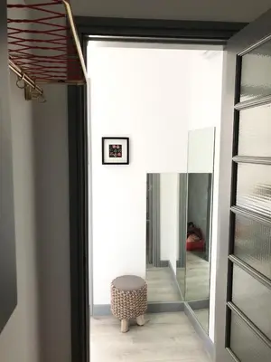 a glass door leading into a room with a stool at Casa da Catedral II in Porto