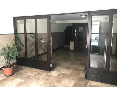 an office building with glass doors and a potted plant at Casa da Catedral II in Porto