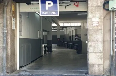 an empty hallway of a building with a parking sign at Casa da Catedral II in Porto