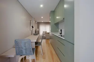 a kitchen with a table and chairs in a room at Liiiving in Porto | Luxury Boutique Apartment in Porto