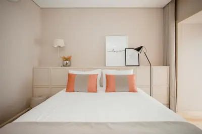 a bedroom with a large white bed with pillows at Liiiving in Porto | Luxury Boutique Apartment in Porto