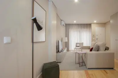 a living room with a couch and a television at Liiiving in Porto | Luxury Boutique Apartment in Porto