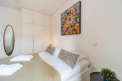 a small room with a bed and a mirror at Nomad's Netto & Subway in Porto
