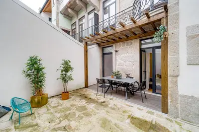 a patio with a table and chairs in a building at Nomad's Netto & Subway in Porto