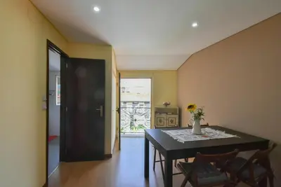 a dining room with a black table and chairs at Clerigos Old Town Apartment in Porto