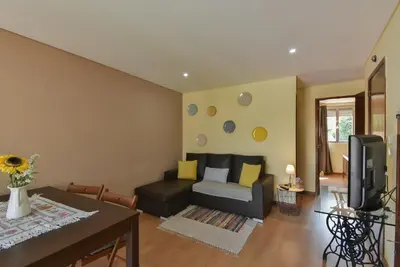 a living room with a couch and a tv at Clerigos Old Town Apartment in Porto