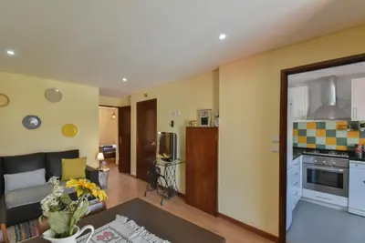 a living room with a couch and a kitchen at Clerigos Old Town Apartment in Porto