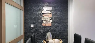 a dining room with a black brick wall at Alexandre Herculano Oporto Residence I II & III in Porto