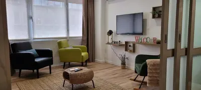 a living room with two chairs and a tv at Alexandre Herculano Oporto Residence I II & III in Porto