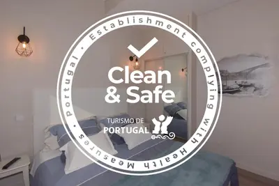 a clock with the words clean and safe in a room at Alexandre Herculano Oporto Residence I II & III in Porto