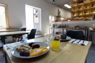 a table with two plates of food and a glass of orange juice at The Gate Porto in Porto