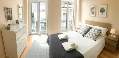 a bedroom with a bed with two towels on it at Porto Luxury Apartments in Vila Nova de Gaia