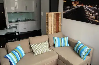 a living room with a couch with pillows on it at 12 Short Term in Porto