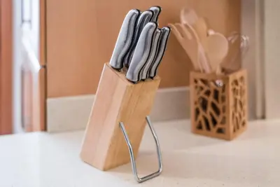 a knife block with six knives in a kitchen at GuestReady - Amaryllis Apartment in Porto