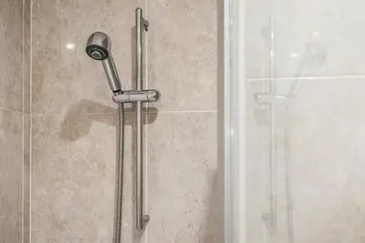 a shower with a shower head in a bathroom at GuestReady - Amaryllis Apartment in Porto