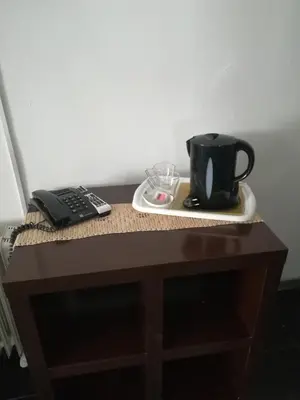 a table with a coffee cup and a remote control at Hotel Cristo Rei in Porto