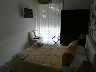 a bedroom with a large bed and a window at Hotel Cristo Rei in Porto