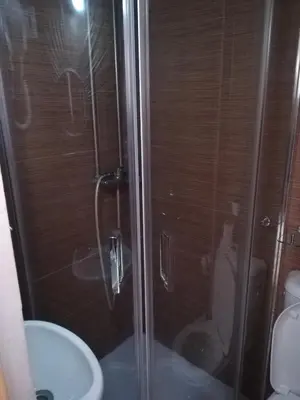 a shower with a glass door next to a toilet at Hotel Cristo Rei in Porto