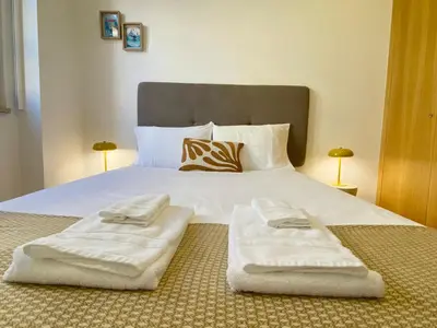 a bedroom with a bed with two towels on it at Vitral House of Art District in Porto