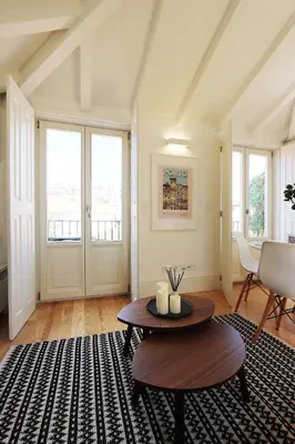 a living room with a table and a rug at HM - Flores Skylight in Porto