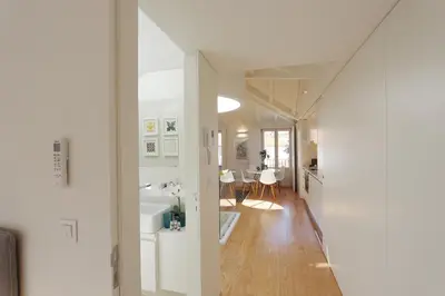 a hallway leading to a kitchen and a living room at HM - Flores Skylight in Porto