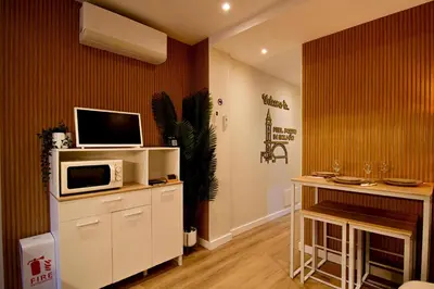 a living room with a tv and a microwave at Feel Porto in Bolhão 