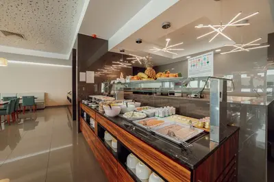 a buffet line with food in a restaurant at ABC Hotel Porto - Boavista in Porto